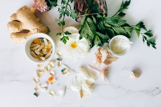 A flatlay of herbal supplements with fresh ginger, garlic, and leaves.